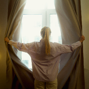 woman opening window